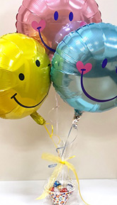 an arrangement of three mylar balloons