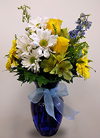 a simple flower arrangement in a light blue transparent vase