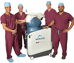 four doctors with MAKOplasty machine