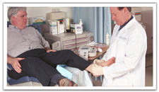 photo of a doctor examining a man's leg